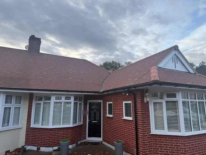 Red-brick bungalow with its newly replaced tiled roof and white gable