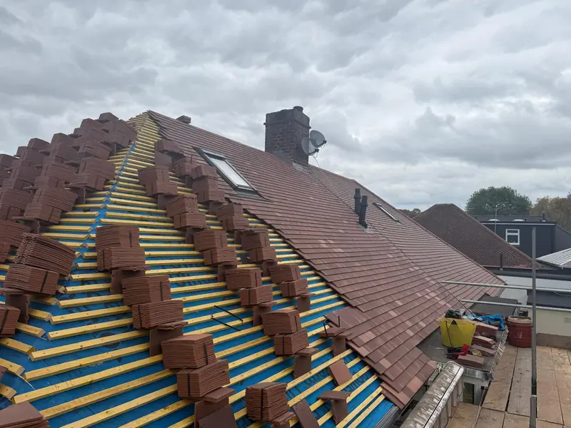 New roof tiles loaded out in stacks along the battens
